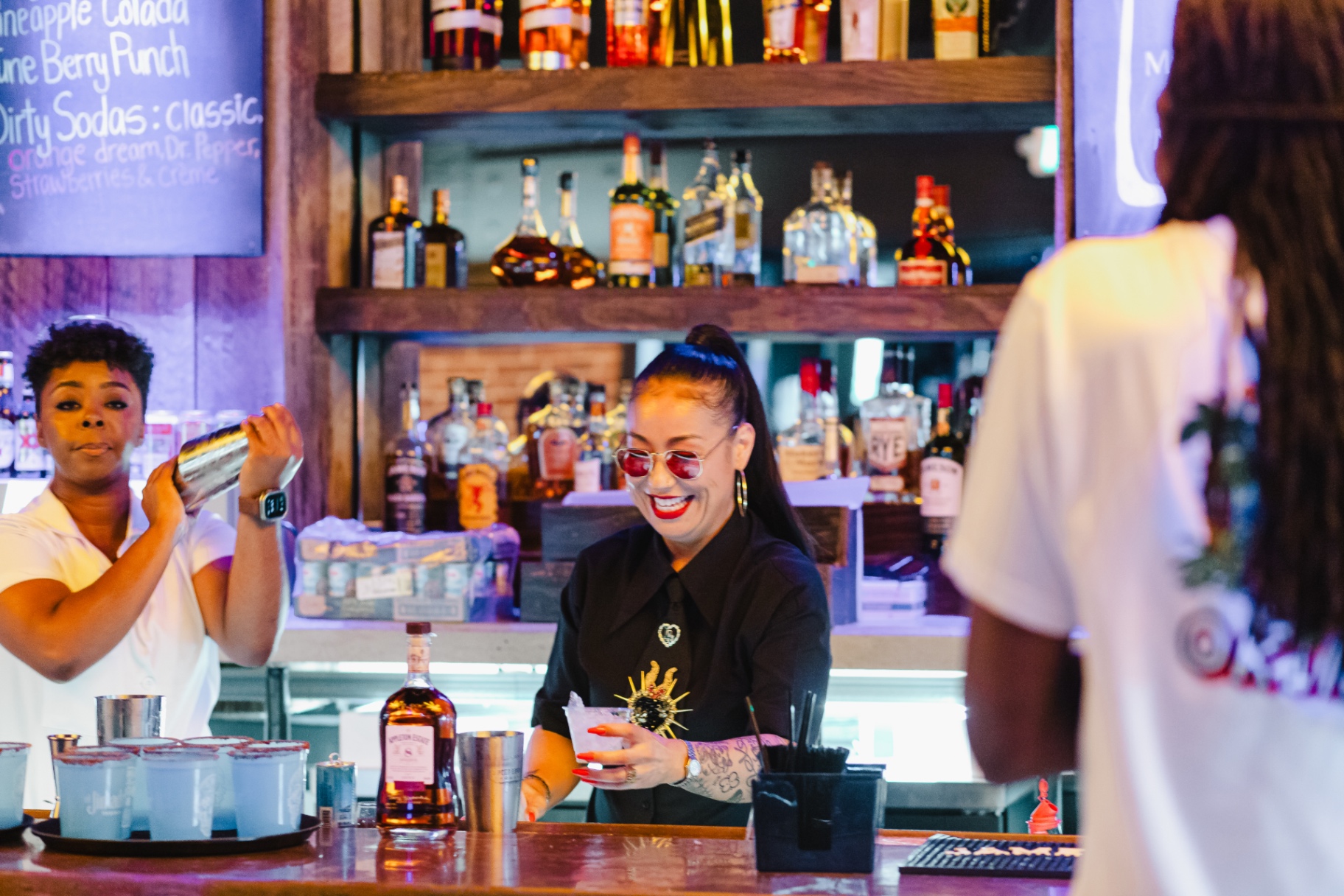 Tassia Lacerda mixing drinks behind the bar at The Cocktail Lab Live