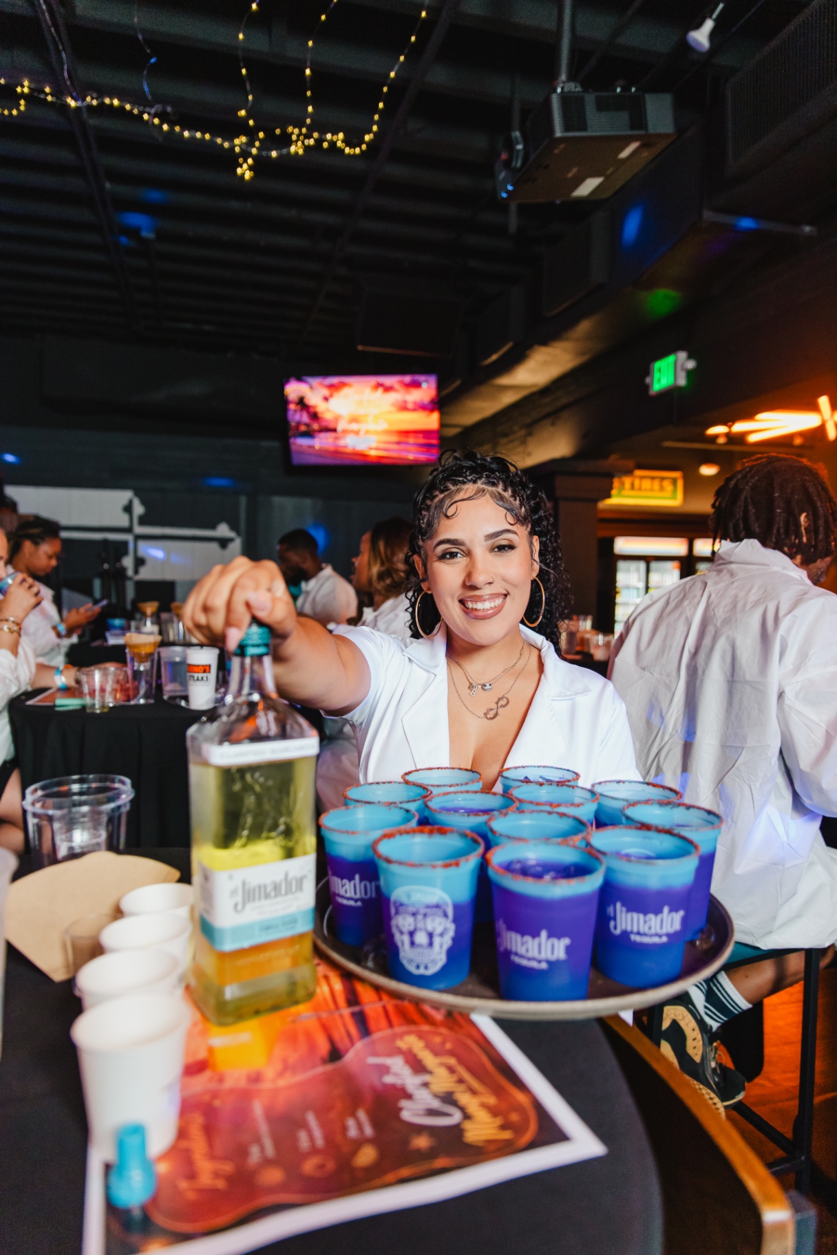 Lab Lady pouring a tray of signature cocktails